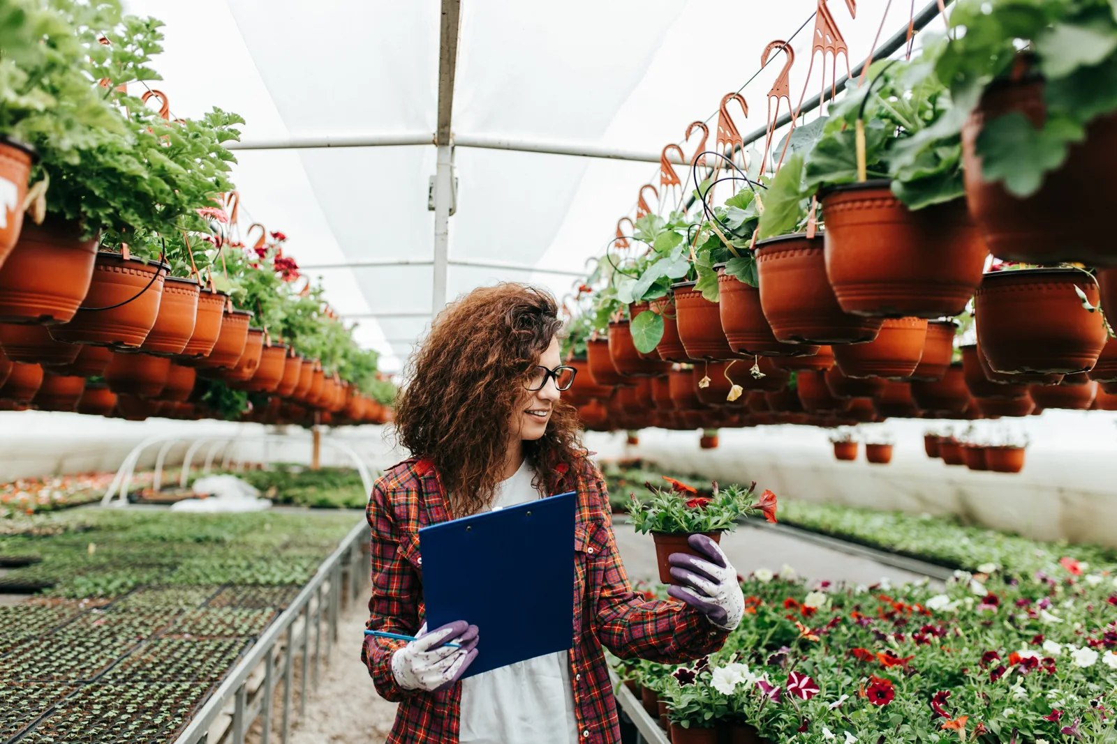 Adult grower documenting conditions with a clipboard